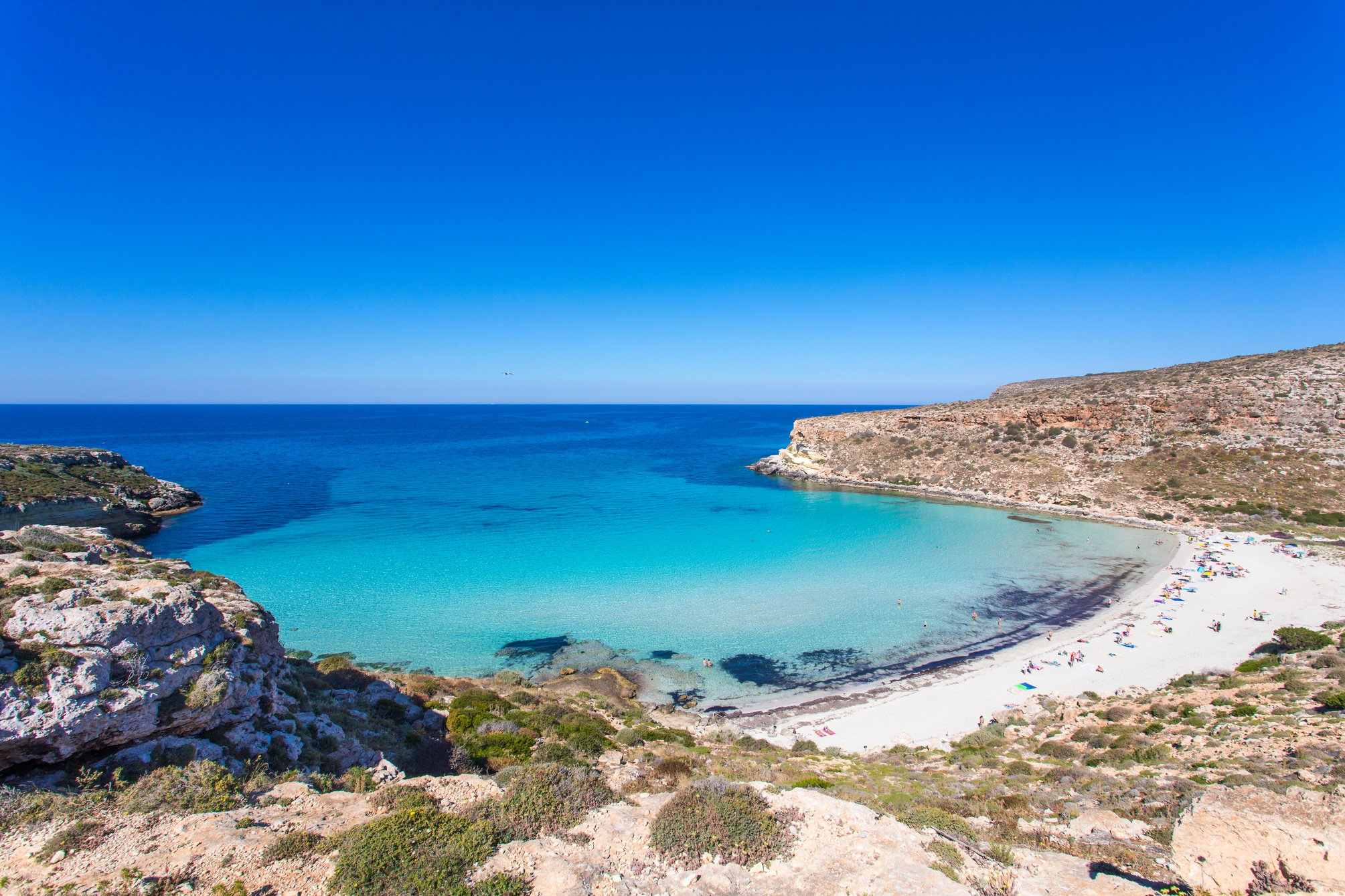 Lampedusa Island Sicily - Rabbit Beach and Rabbit Island Lampedusa “Spiaggia dei Conigli” with turquoise water and white sand at paradise beach. Mediterranean scrub with thyme and cardoon. Tabaccara Bay